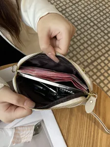 Genuine leather phone bag showing interior compartments for cash and phone
