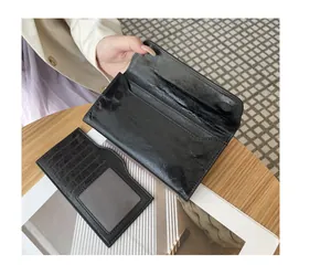 Vista detallada de cartera larga de cuero negro arrugado con tarjetero extraíble