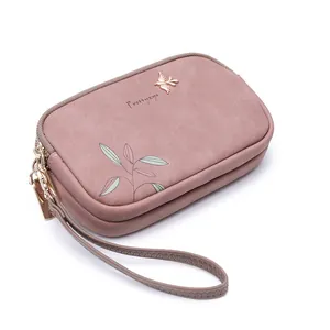 Dusty rose double zipper clutch bag with leaf print and golden bird motif detail