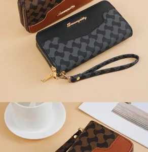 Detailansicht des geometrischen Drucks und des Doppelreißverschlusses der langen Damen-Clutch.