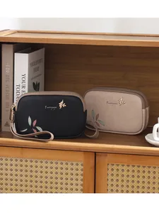 Elegant Prettyzys double zipper wristlet bag wallet with chic leaf print and bird logo