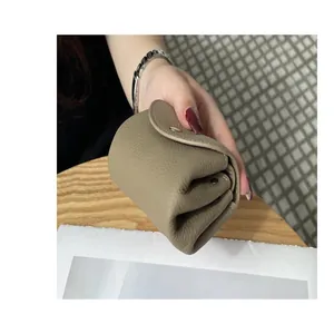 Close-up view showing the soft leather texture of a mini khaki genuine leather coin purse