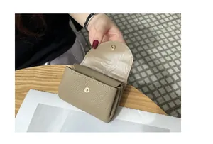 Close-up detail of a khaki genuine pebbled leather mini wallet with snap closure