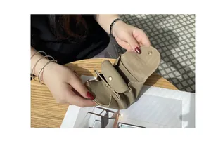 Close-up interior view of a soft tan leather Japanese-style mini coin purse with snap.