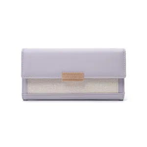 Front view of long lavender wallet with woven texture and decorative gold-tone hardware.