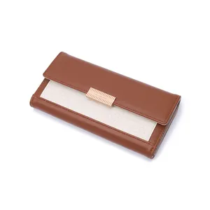 Detailed view of women's vintage woven color-block long wallet with gold metal clasp