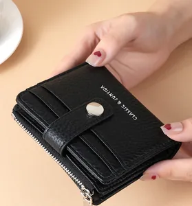 Detailed view of black lychee pattern PU leather wallet with silver snap and zipper