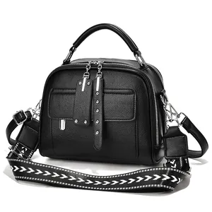 Elegant black textured leather handbag with stylish geometric patterned wide strap.