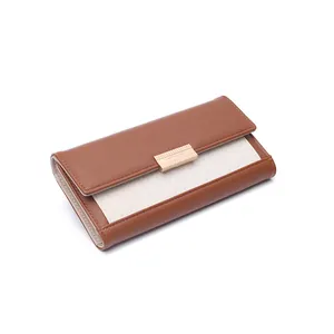 Close-up of the woven texture and metal clasp detail on this brown color-block wallet