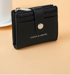 Close-up of black lychee texture PU leather short coin purse with top zipper detail