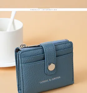 Close-up view showing the pebbled texture of this blue PU leather wallet with metal zipper
