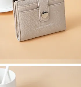 Close-up of litchi grain PU leather short wallet with card slots and snap button