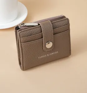 Detailed view of brown litchi grain PU leather wallet with zipper and snap