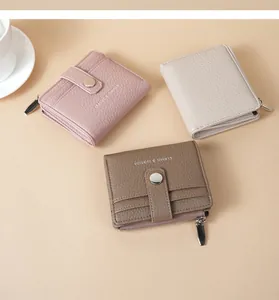 Three elegant lychee pattern PU leather wallets in pink, beige, and brown with zippers.