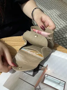 Compact genuine leather mini wallet featuring card slots and coin pocket in khaki color