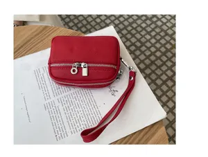 Red mini pebbled leather coin purse with double silver zippers and wrist strap detail