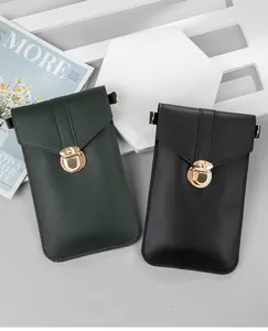 Detail shot of dark green and black minimalist crossbody phone bags with gold locks.