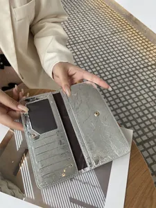Gedetailleerde macro-opname van een zilveren metallic damesportemonnee met veel kaartvakken