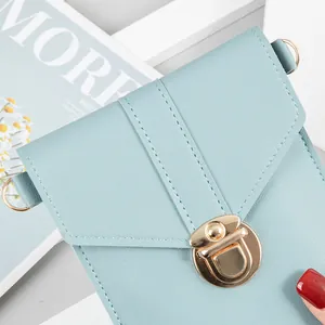 Minimalist light blue crossbody phone bag with an elegant gold-tone lock clasp closure