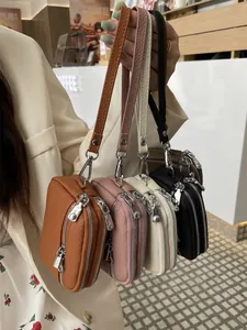 Fashionable set of four multi-colored mini double-zipper leather coin purses with straps