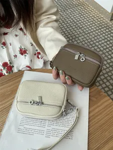 Stylish mini leather coin purse for women with double zippers and portable wrist strap