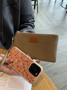 Elegant genuine leather clutch bag for women with zipper and chic floral phone case detail