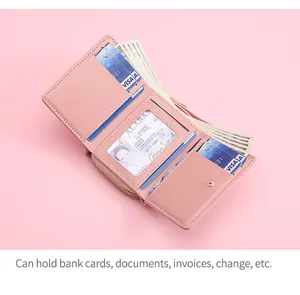 Detailed interior view of pink bi-fold wallet showing card slots and cash compartment