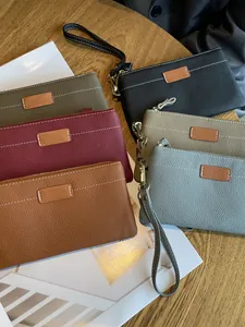 Genuine leather small clutch purses with wristlets in multiple colors for women.