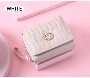 Close-up of a delicate pink folding wallet with wave stitching and a gold wheat ear V logo.