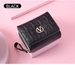 Close-up of black quilted short wallet featuring gold V logo and wavy stitching