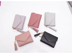 Detailed view of women's mini folding wallets in five colors with heart tassel charms.