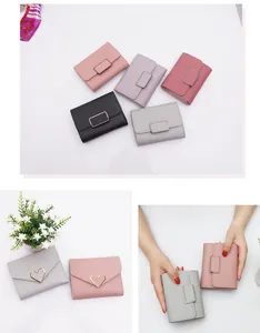 A detailed macro view showing various colors and heart-shaped metal buckle on mini wallets