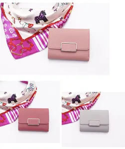 Detailed view of compact women's folding wallets in elegant pink and grey leather tones