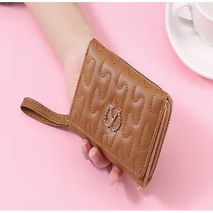 Detailed view of brown wallet with wave stitching and decorative wheat wreath V logo