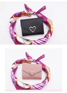 Detailed view of elegant black and pink mini heart wallets with decorative silk scarf
