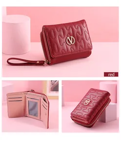 Detailed view of red quilted wallet with gold V-logo and multi-slot interior