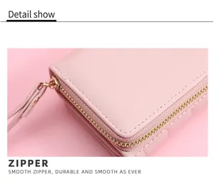 Close-up of durable gold-tone zipper on a pink leather wallet with fine stitching