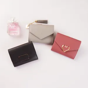 Mini foldable women's wallets in black, grey, and pink with heart and tassel details