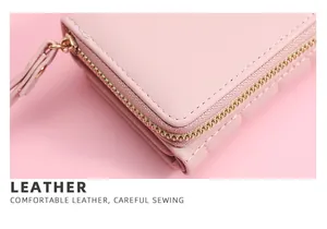 Close-up of pink leather wallet showing high-quality zipper and stitching details