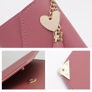 Detail shots of a pink mini wallet featuring heart charm and tassel