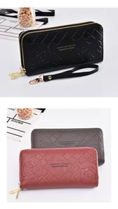 Detailed view of women's long wallets with embossed flower pattern and double zippers