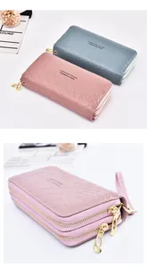 Detailed view of women's long wallet with double zippers, rose embossing, and wrist strap.