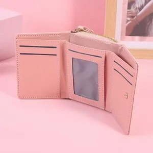 Elegant pink trifold wallet for women featuring multiple card slots and a coin pocket