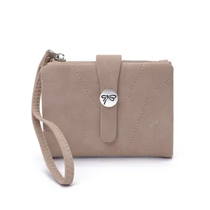Compact beige faux leather wallet with butterfly clasp and wrist strap