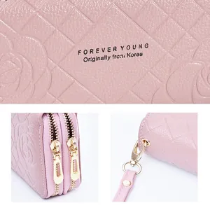 Pink long quilted camellia wallet for women featuring double zipper and wrist strap