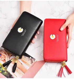 Detail of black and red women long wallets with daisy emblem and double zippers