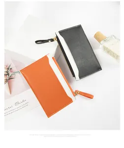 Detail view of contrast color PU leather zip card holder and coin purse on white background