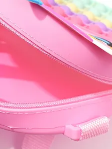 Close-up of a pink unicorn silicone pop-it backpack for children fidget toy bag