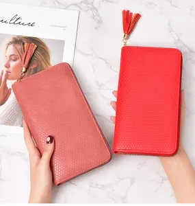 Close-up showing the elegant woven texture and tassel zipper of a long women's clutch wallet