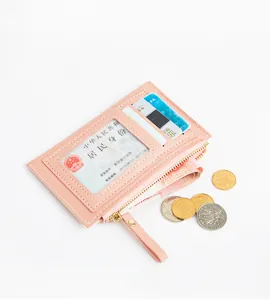 Macro view of pink PU leather card holder with ID window and zipper coin pocket.